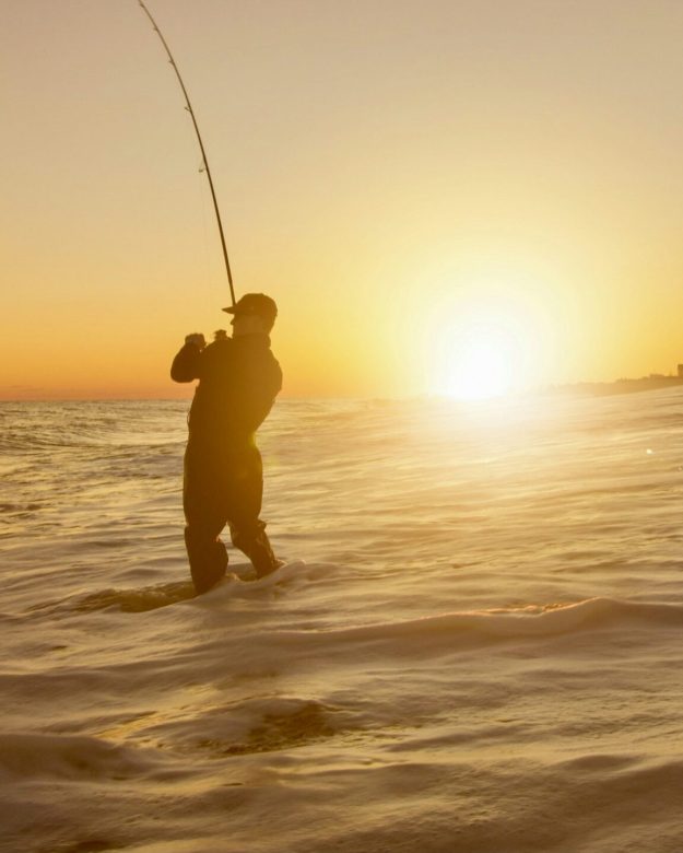 Angler fishing at the sunset